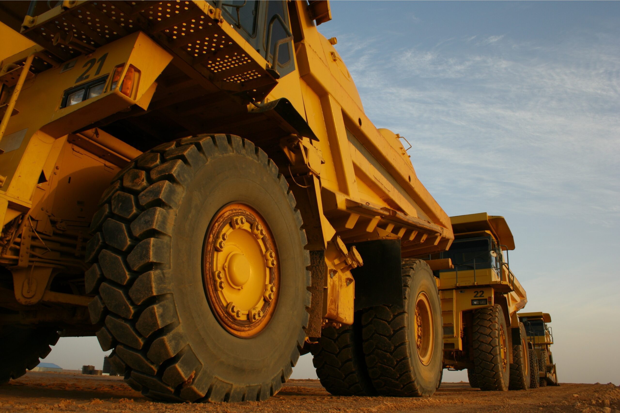 Mining Machines parked up on a dirt road during a shift change.